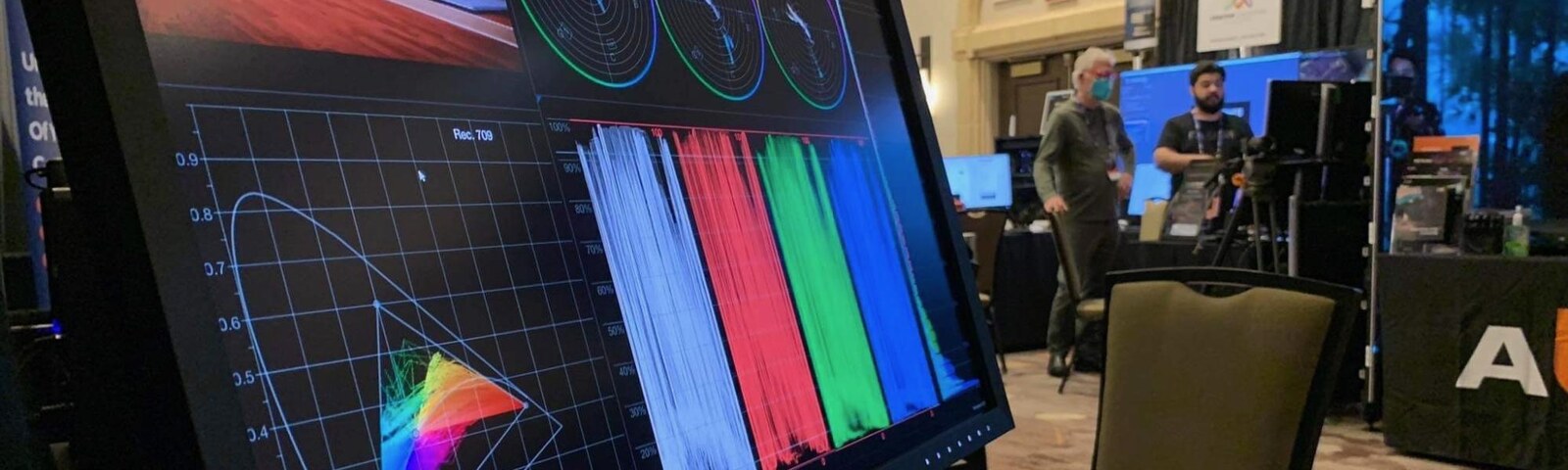 Nobe OmniScope running a CIE plot, waveform and vectorscopes on a monitor at a trade show booth